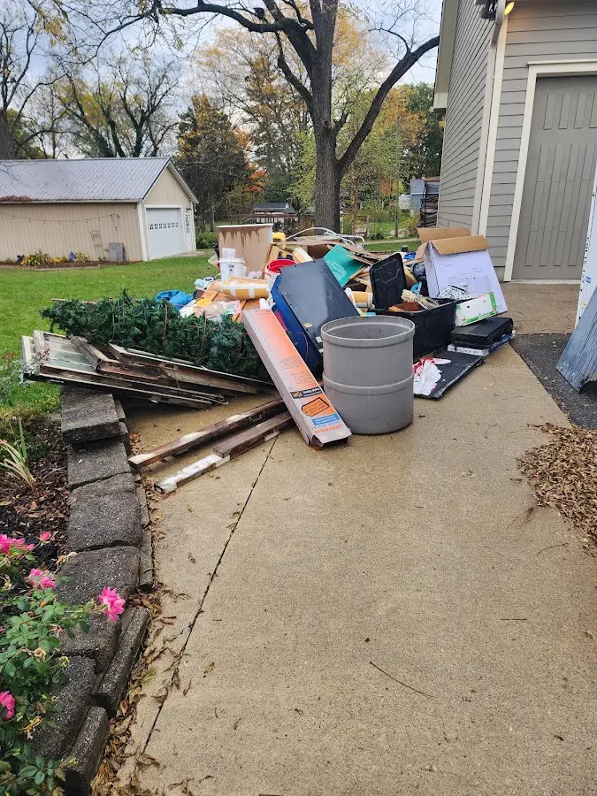 Dumpster being loaded with debris for Residential Dumpster Rental in Fredericksburg